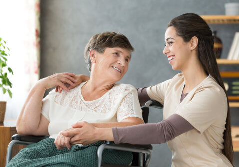 senior and caregiver smiling